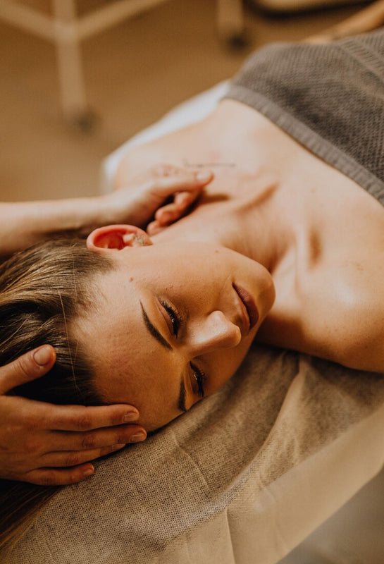 Aesthetician giving a relaxing facial treatment